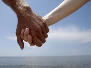 Hand-holding causes levels of the stress hormone cortisol to drop, says Matt Hertenstein, an experimental psychologist at DePauw University in Indiana. This couple joined hands while protesting offshore oil drilling in the wake of the Deepwater Horizon spill during a Hands Across the Sand event in Gulfport, Miss. Gregory Bull/AP